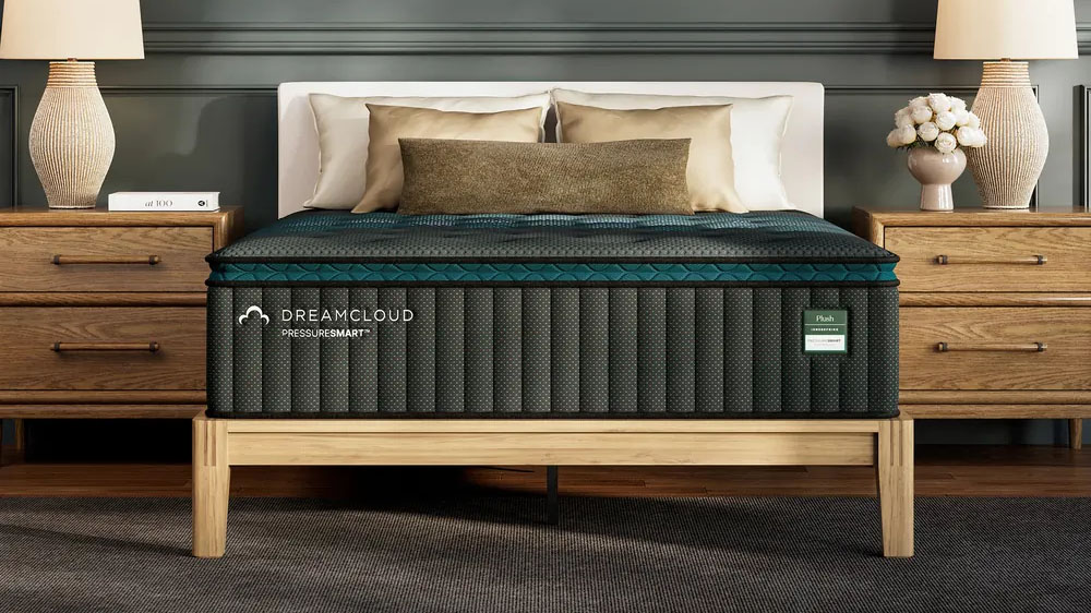 The DreamCloud PressureSmart Plush Mattress on a bedframe in a decorated bedroom