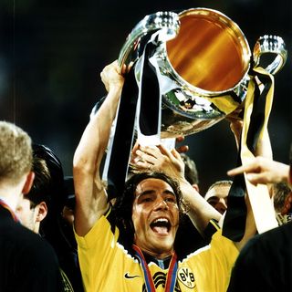 Paulo Sousa celebrates with the Champions League trophy after victory over Juventus in the 1997 final.