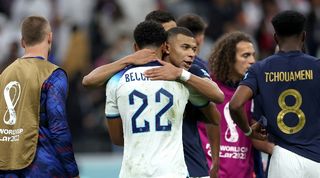 Jude Bellingham and Kylian Mbappe embrace after the World Cup quarter-final between England and France in December 2022.