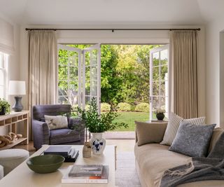 living room with neutral scheme and doors open to garden