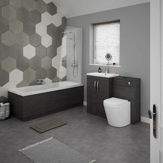 modern bathroom suite with wooden panelling, statement hexagon wall tiles and grey tiled flooring