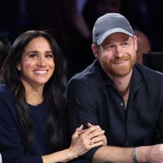 Meghan Markle linking arms with Prince Harry