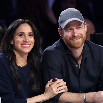 Meghan Markle linking arms with Prince Harry