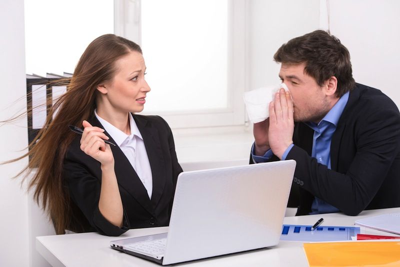 A woman gets sneezed on by her coworker