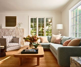 living room with blue sofa and patterned chair