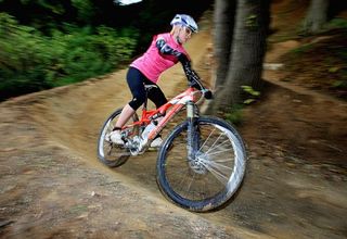 Maddie Horton speeds through a banked turn on the London area Olympic mountain bike course.