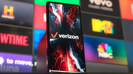 Phone held in the hand with Verizon Wireless logo on screen.