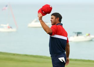 Koepka waves his hat after winning his match at the 2020 Ryder Cup