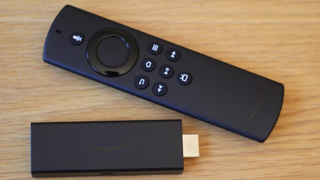 The Amazon Fire TV Stick Lite pictured on a wooden surface