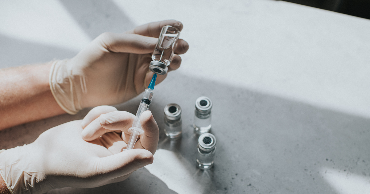 Where to get Botox: Gloved hand holds a syringe and a phial - Conceptual medical image