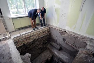 Vilnius mayor Remigijus Simasius (left) and excavation leader Jon Seligman inspect the bimah, or prayer platform, of the Great Synagogue, now buried beneath a former school.