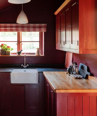 farrow and ball bamboozle painted cottage kitchen with a butler sink and gingham window blind