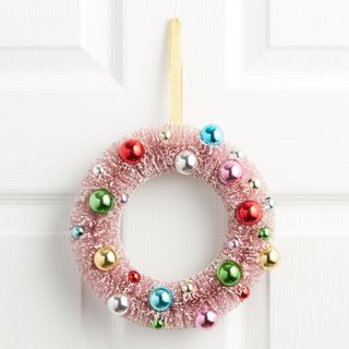 Pink bottlebrush wreath with ornaments around it