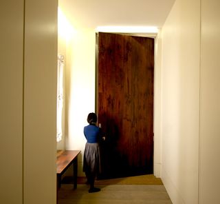 The entrance door - a vast slab of 200-year old Rhodesian Teak – stands nearly 4 metres high