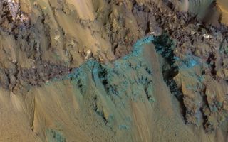 Taken by NASA's Mars Reconnaissance Orbiter, this photo highlights the exposed, colorful bedrock of the planet's Hale Crater. This impact crater measures over 62 miles (100 km) across and is marked by a number of stunning, visual features.