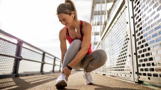 Sportswoman with injured ankle making a painful face