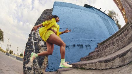 best women's running shoes: women running up steps on street in the Lululemon Blissfeel Running Shoes