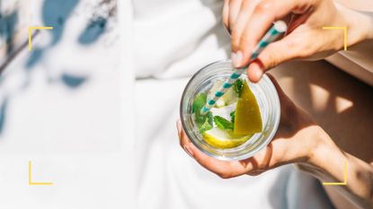 Woman drinking water with fresh lemon, lime and mint 