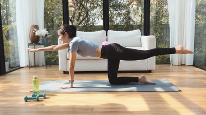 Woman exercising on an exercise mat at home
