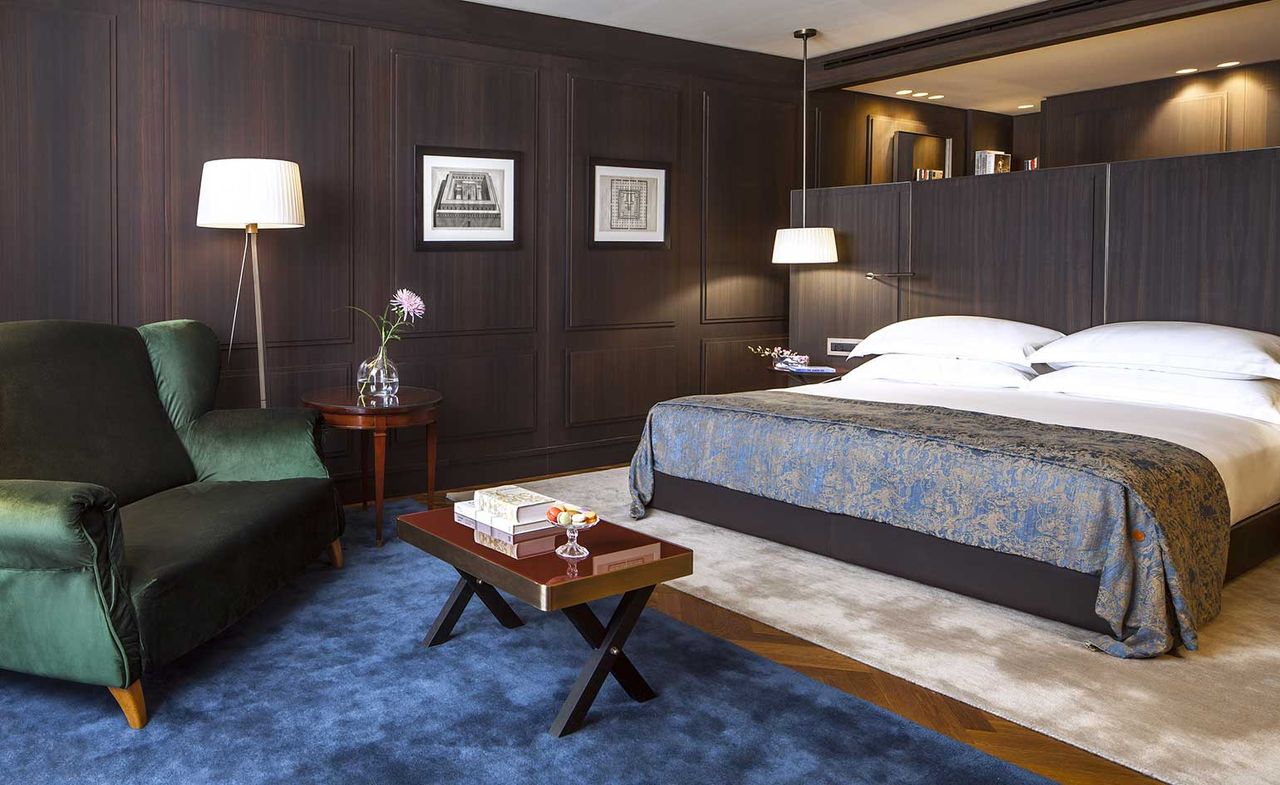 Interior of bedroom suite with dark wooden walls