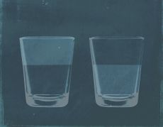 A half full glass of water next to a half empty glass of water