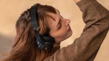 Anker Soundcore Life Q30 wireless headphones being worn by a woman dancing