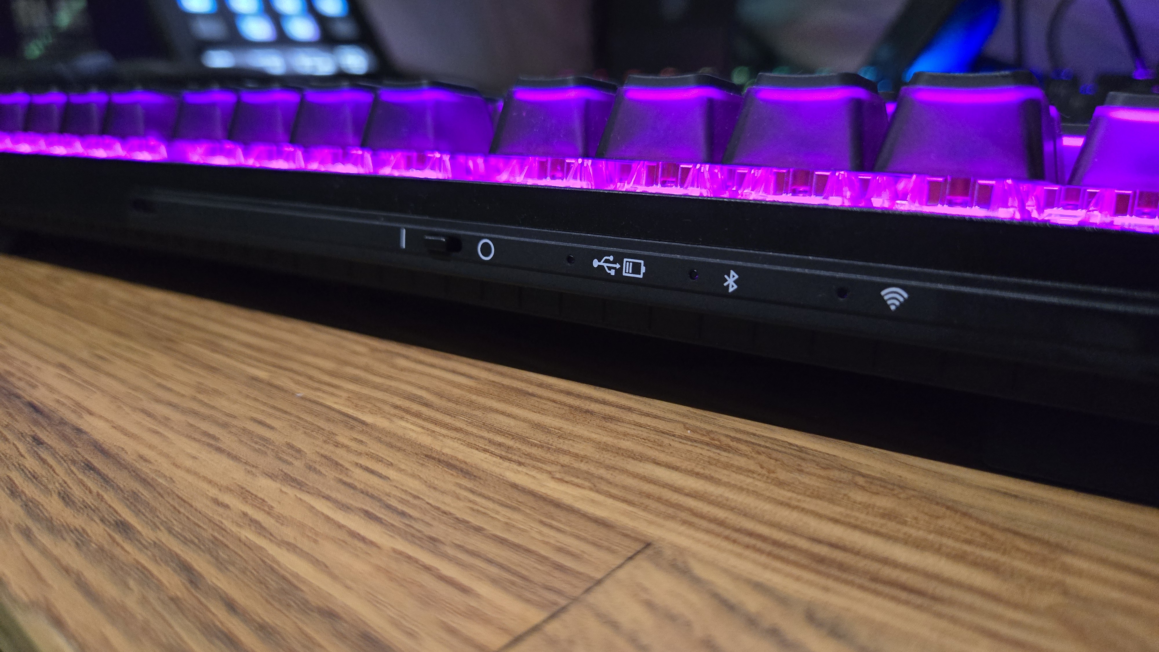 The back side of the Cherry MX 8.2 Wireless Xaga. The RGB lights are on and bathe the keys in a purple light.