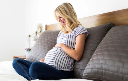 Pregnant woman holding her baby bump 