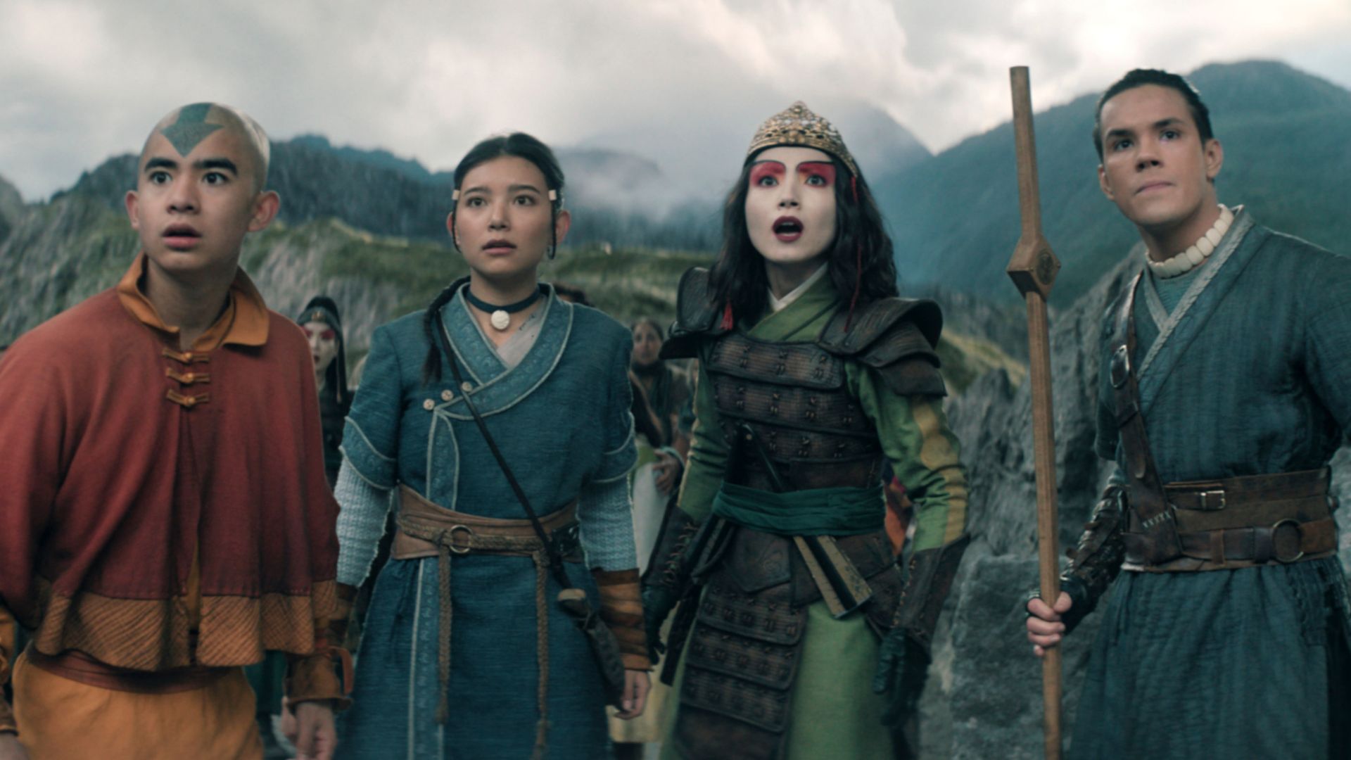 Aang and his friends stands in front of a mountain