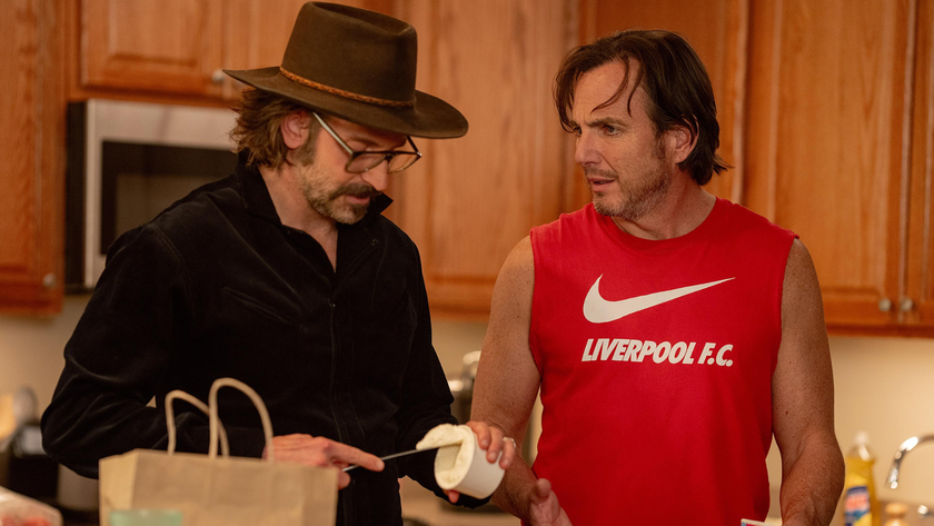 Bradley Cooper talks to Will Arnett in a kitchen