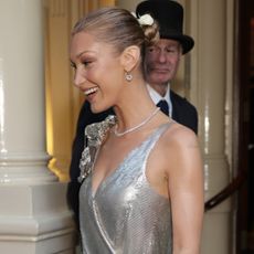 Bella Hadid in London wearing a silver dress with a slick back bun