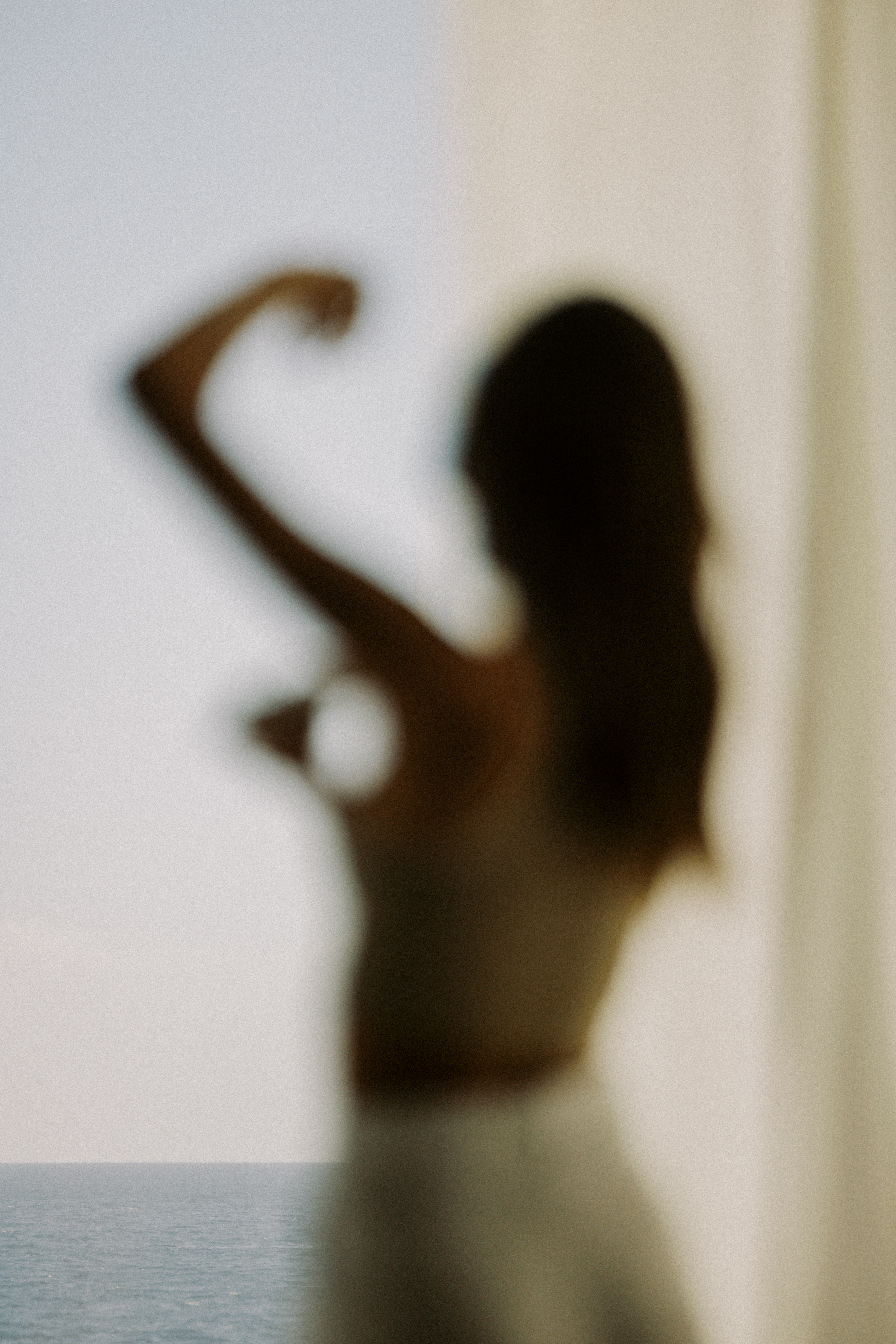 A blurry photo of a model mid-application of one of the best women's deodorants.