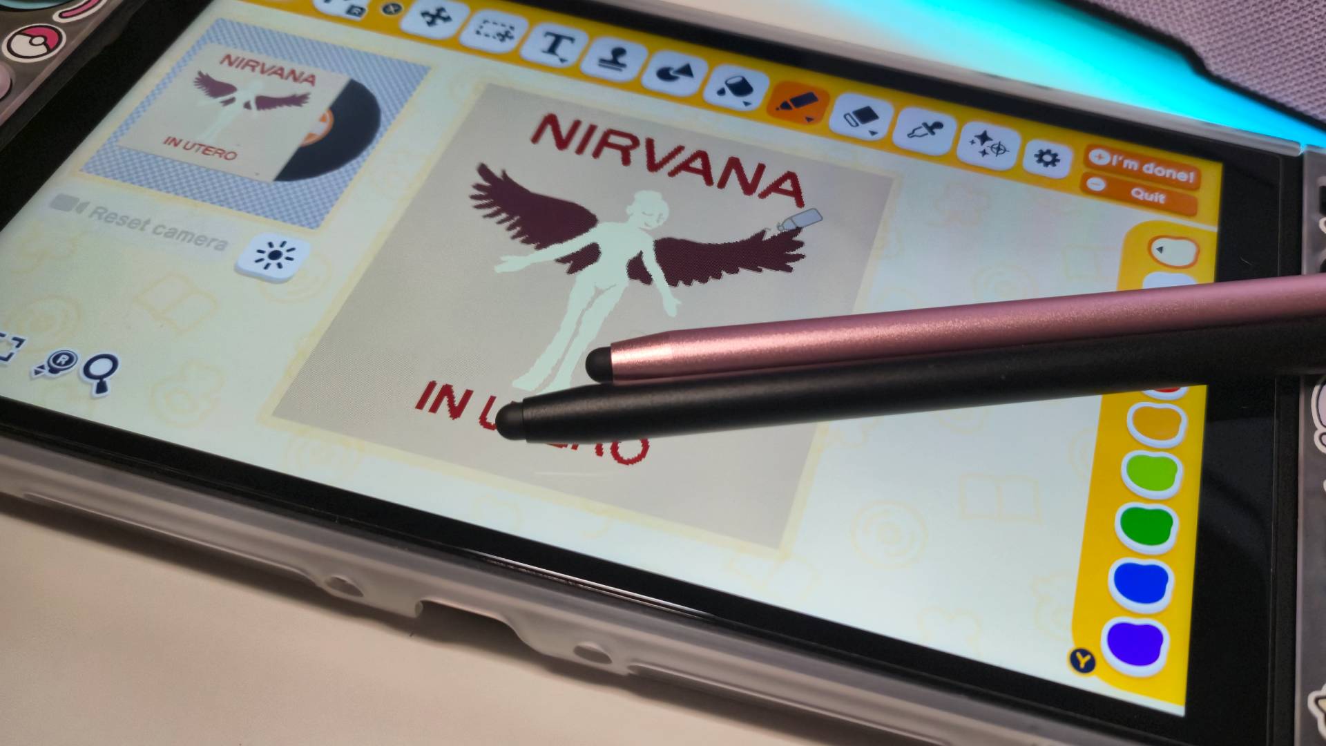 Photo of a pair of touch stylus pens sitting on a Switch 2.