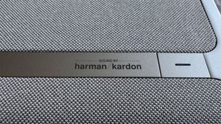 Xgimi Aura 2 home cinema projector close up on volume control with Harman Kardon logo