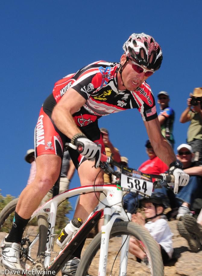A Sour Mash rider plunging down a slickrock descent