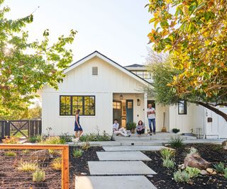 front yard design with rocks and mulch, and people outside their house