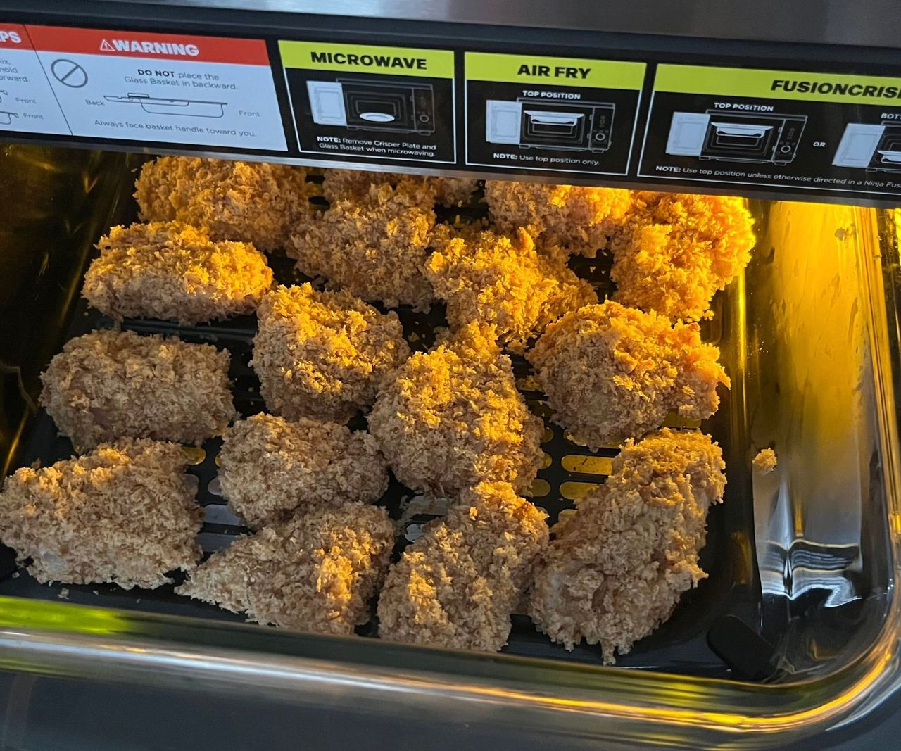 Breaded chicken nuggets in a glass air fryer