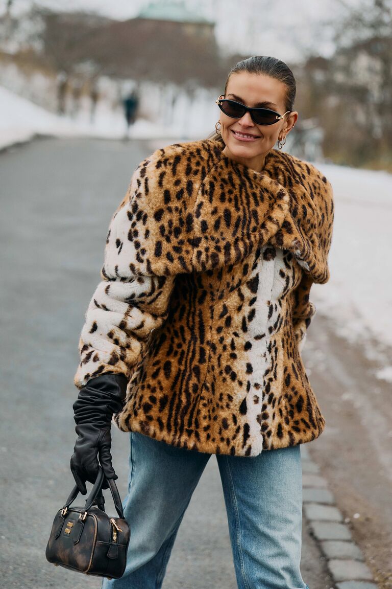 Photo of woman wearing coat at Copenhagen Fashion Week.
