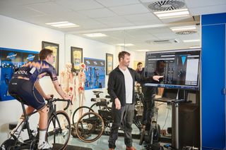 Phil Burt looking at the data collected during a bike fit with a male cyclist