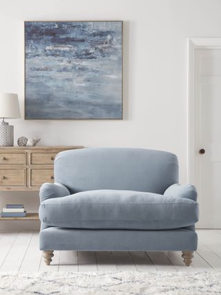 blue armchair with seascape painting