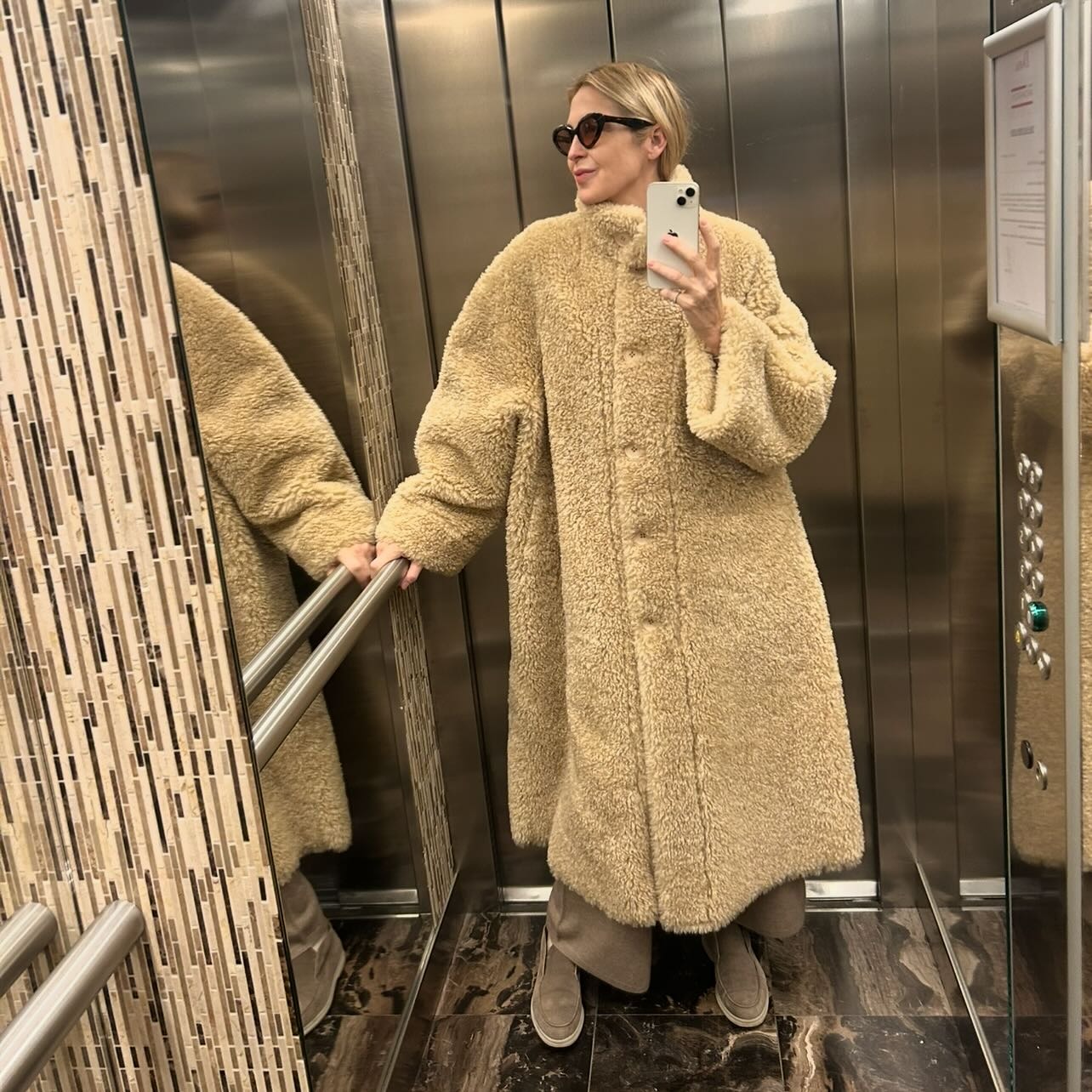 Kelly Rutherford taking an elevator mirror selfie.