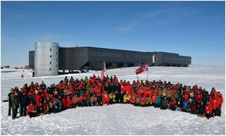 Norwegian Prime Minister Jens Stoltenberg – in front of the sign – is surrounded by U.S. Antarctic Program personnel at the geographic South Pole on Dec. 14, 2011, the centennial of Roald Amundsen's arrival.