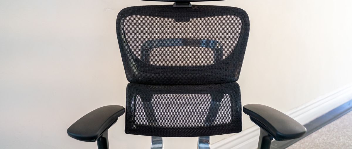 A black mesh OdinLake Ergo PLUS 743 office chair in an office hallway