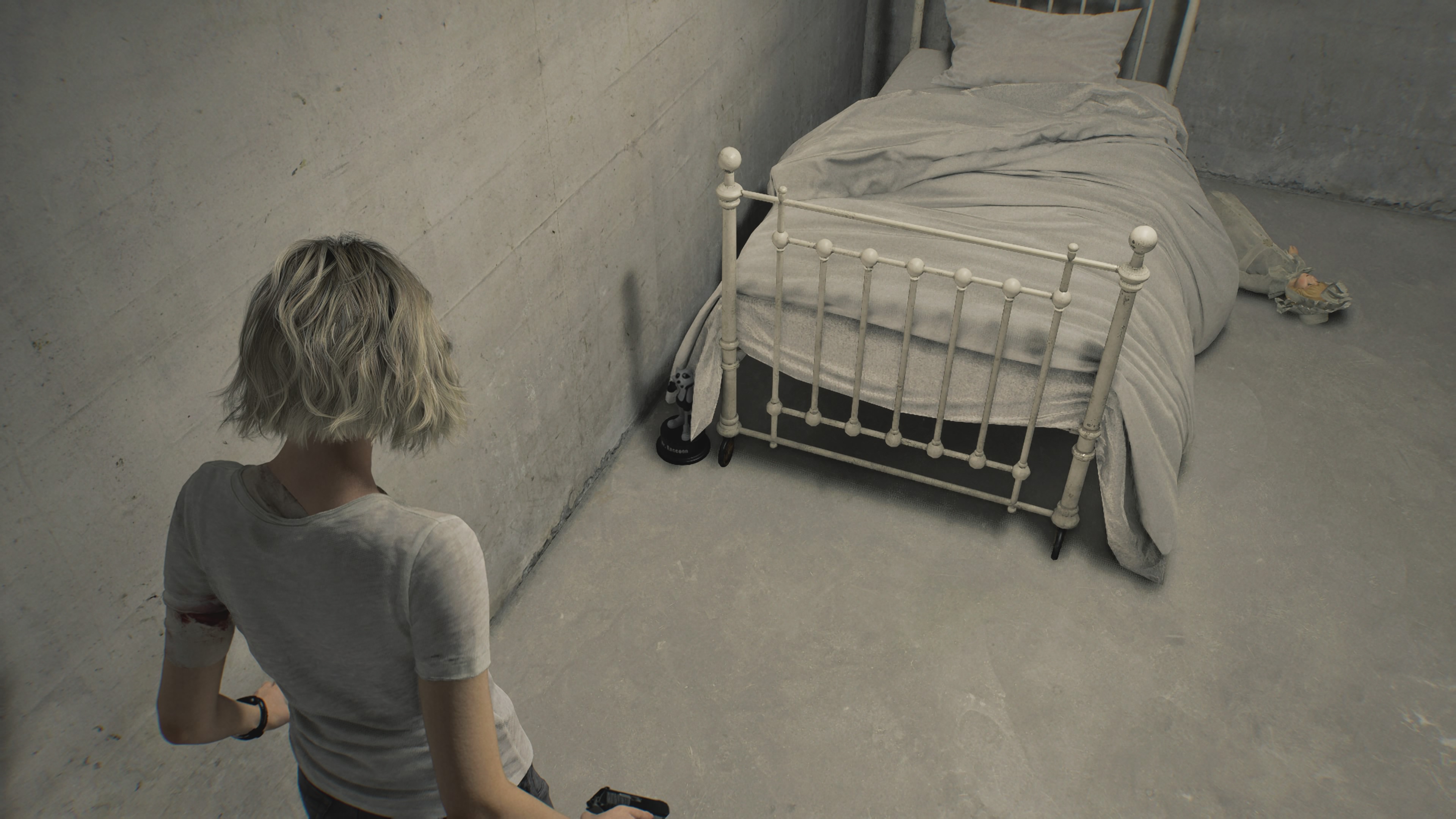 Resident Evil Requiem Mr. Raccoon behind a bed