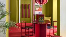 a room with a red floor and furniture and bright green walls
