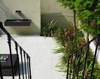 small water feature and pond in paved courtyard garden