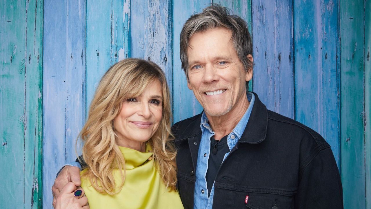 kyra sedgwick and kevin bacon on a blue background