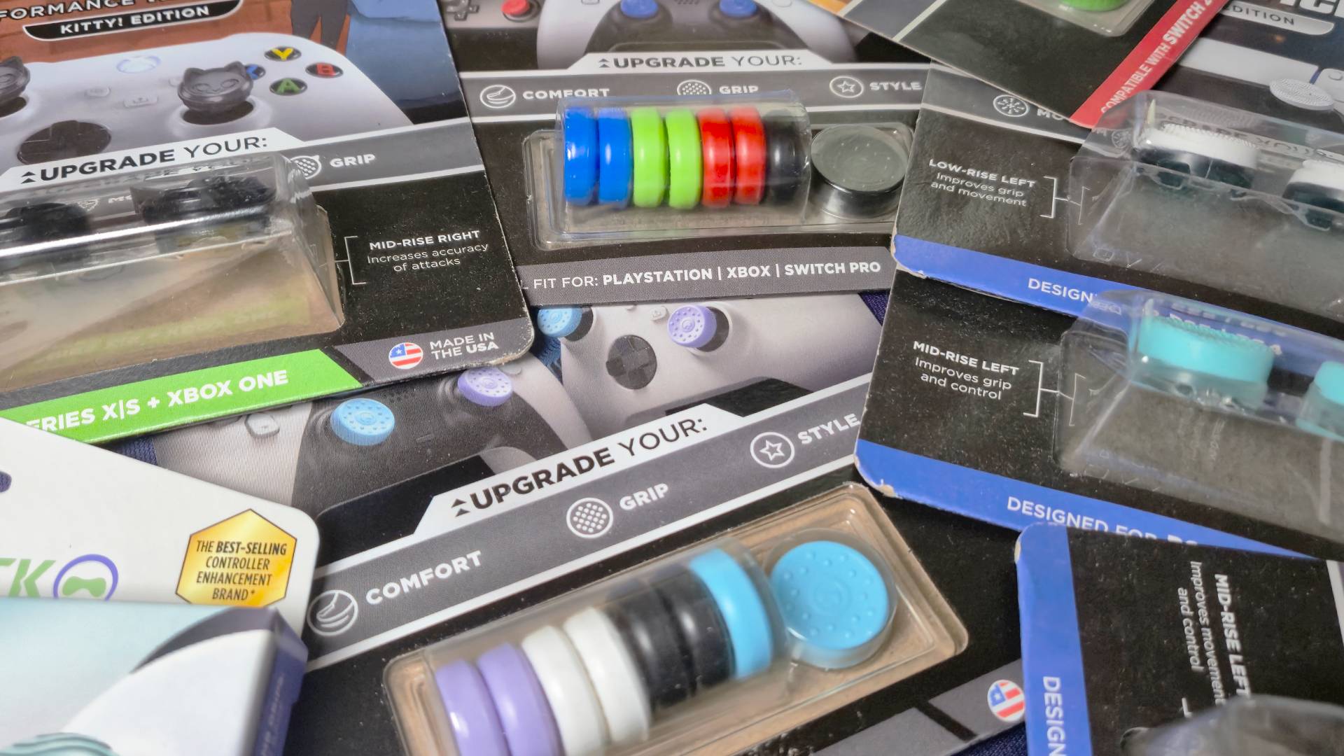 Photo of a big selection of KontrolFreek thumb grips sitting on a desk.