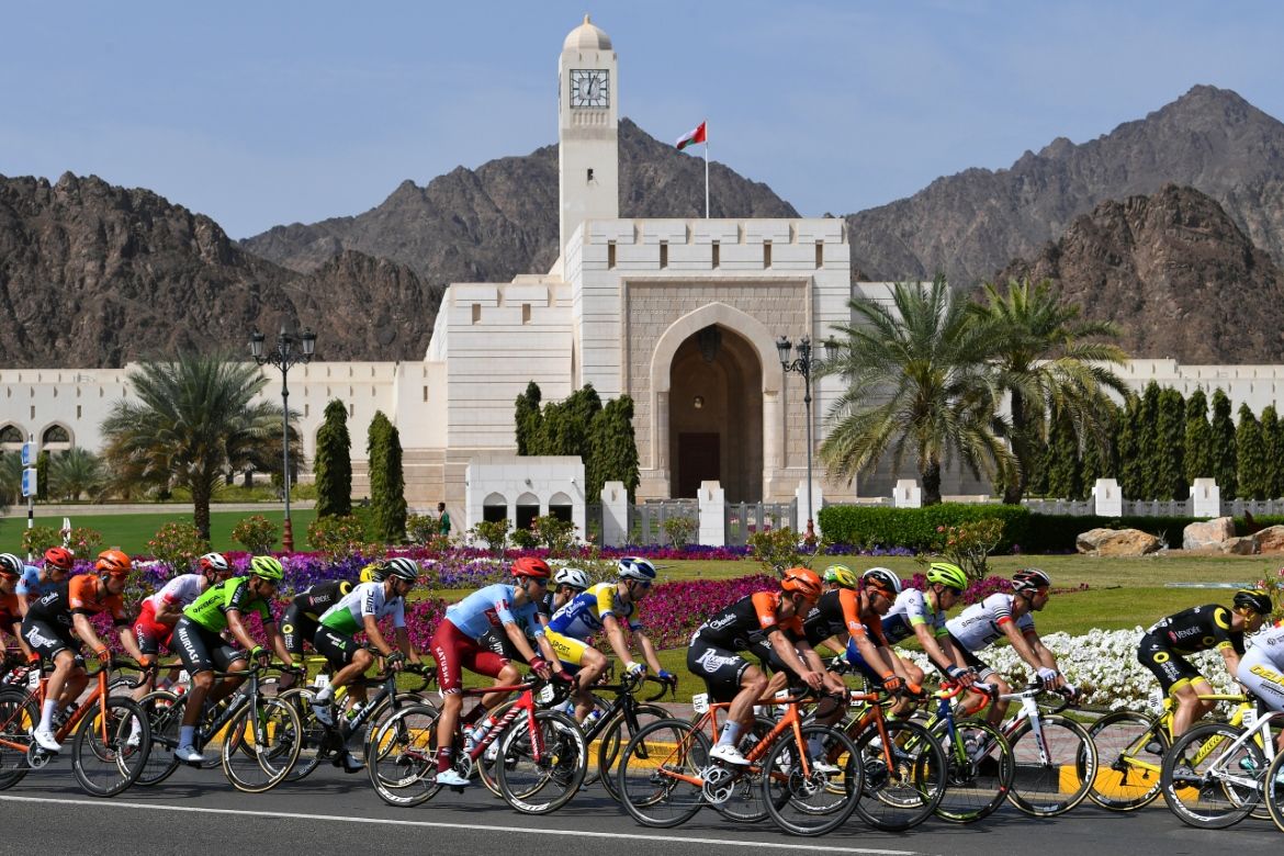 The peloton passes a mosque during stage 4 of the Tour of Oman