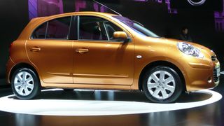 Side view of gold Nissan Micra